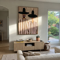 Black Brims Frame Blush - black hat striped pair painting by Elliot Vale, modern figurative vertical wall art – styled room scene view 1