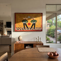 Twin Figures Frame Sun - geometric western pair painting by Elliot Vale, modern figurative horizontal wall art - styled room scene view 2