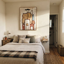 Bags Wait Beside Figures - abstract traveler family painting by Elliot Vale, modern figurative vertical wall art - styled room scene view 4