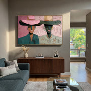 Pink Brims Frame Smiles - smiling hat figure pair painting by Elliot Vale, modern figurative horizontal wall art - styled room scene view 1