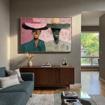 Pink Brims Frame Smiles - smiling hat figure pair painting by Elliot Vale, modern figurative horizontal wall art - styled room scene view 1