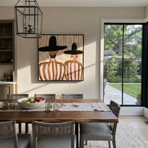 Black Brims Hold Blush - bearded hat figure pair painting by Elliot Vale, modern figurative square wall art - styled room scene view 1