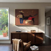 Three Shadows Share Rope - cowboy horse companion painting by Elliot Vale, modern figurative horizontal wall art - styled room scene view 2