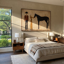 Gentle Hand Meets Horse - horse handler couple painting by Elliot Vale, modern figurative horizontal wall art - styled room scene view 4