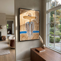 Blue Stripes Meet Sand - blue striped sombrero figure painting by Elliot Vale, modern figurative vertical wall art - styled room scene view 2