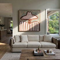 Pink Brim Softens Lines - pink hat striped figure painting by Elliot Vale, modern figurative square wall art - styled room scene view 4