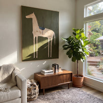Empty Saddle Waits Green - minimal saddled horse painting by Elliot Vale, modern figurative vertical wall art - styled room scene view 1