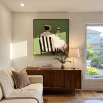Raised Glass Meets Green - seated wine woman painting by Elliot Vale, modern figurative square wall art - styled room scene view 3