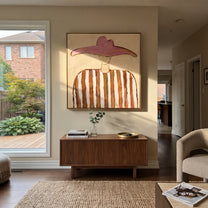 Rose Wings Float Softly - brown striped hat figure painting by Elliot Vale, modern figurative square wall art - styled room scene view 2