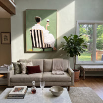 White Dress Raises Wine - seated wine woman painting by Elliot Vale, modern figurative vertical wall art - styled room scene view 3