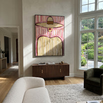 Sand Brim Meets Pink - pastel striped hat figure painting by Elliot Vale, modern figurative vertical wall art - styled room scene view 2