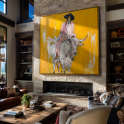 Mustard Dust Carries Pink - pink cowboy on white longhorn painting by Ethan Mercer, contemporary western square wall art – styled room scene view 1