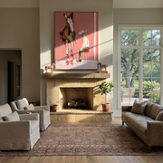 Quiet Chair Meets Horse - seated cowboy and horse painting by Ethan Mercer, contemporary Western vertical wall art – styled room scene view 1