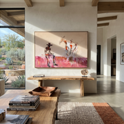 Pink Dust Holds Distance - cowboy and paint horse painting by Ethan Mercer, contemporary Western horizontal wall art – styled room scene view 1