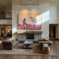 Pink Dust Holds Distance - cowboy and paint horse painting by Ethan Mercer, contemporary Western horizontal wall art – styled room scene view 4