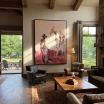 Blush Ground Holds Waiting - cowboy and paint horse painting by Ethan Mercer, contemporary Western vertical wall art – styled room scene view 1
