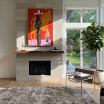 Golden Bull Shadows Cowgirl - cowgirl and bull painting by Ethan Mercer, contemporary Western vertical wall art – styled room scene view 2