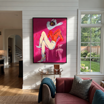 Scarlet Hat Guards Rest - reclining cowgirl painting by Ethan Mercer, contemporary Western vertical wall art – styled room scene view 1