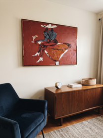 Burgundy Glass Holds Midnight - seated cowgirl martini portrait by Ethan Mercer, contemporary Western horizontal wall art – styled room scene view 9