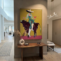 Twin Glasses Balance Night - cowgirl black bull painting by Ethan Mercer, contemporary Western vertical wall art – styled room scene view 1