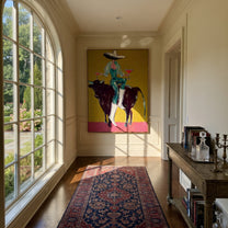 Twin Glasses Balance Night - cowgirl black bull painting by Ethan Mercer, contemporary Western vertical wall art – styled room scene view 2