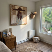 Braided Silence Waits Indoors - cowgirl under hat portrait by Ethan Mercer, contemporary Western square wall art – styled room scene view 5
