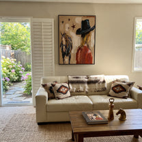 Black Brim Shelters Trust - cowgirl horse closeup painting by Ethan Mercer, contemporary Western vertical wall art – styled room scene view 4