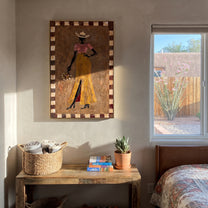 Golden Trousers Carry Flowers - standing cowgirl floral portrait by Ethan Mercer, contemporary Western vertical wall art – styled room scene view 3