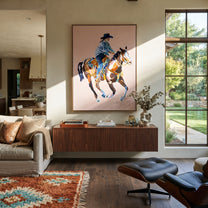 Blue Rider Floats Pale - cowboy pink horse painting by Ethan Mercer, contemporary Western vertical wall art – styled room scene view 1
