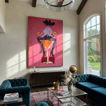 Two Hats Share Glass - two cowgirls martini painting by Ethan Mercer, contemporary Western vertical wall art – styled room scene view 2
