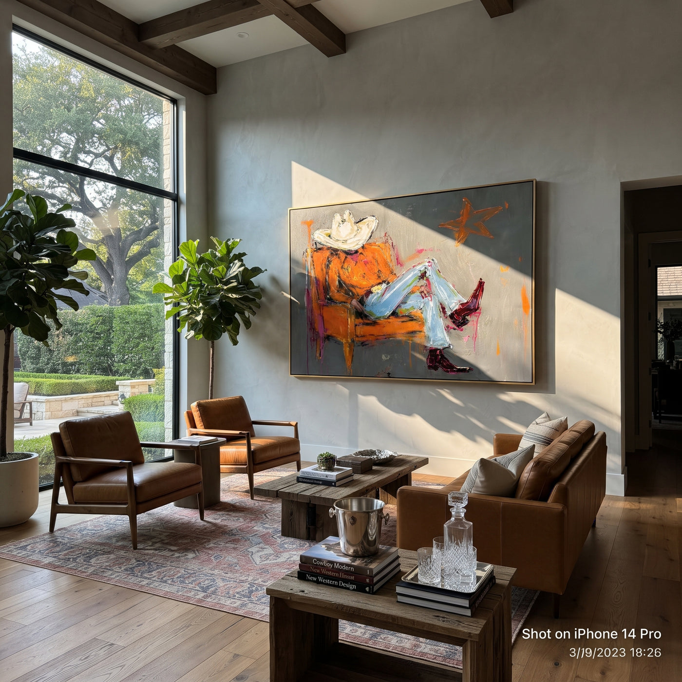 Orange Chair Spans Gray - reclining cowboy chair painting by Ethan Mercer, contemporary Western horizontal wall art – styled room scene view 3