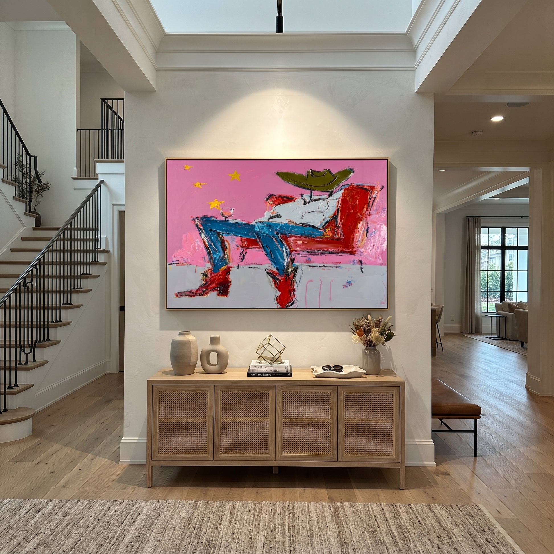 Red Chair Drifts Pink - reclining cowboy chair painting by Ethan Mercer, contemporary Western horizontal wall art – styled room scene view 5