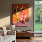 Donkey Keeps Her Company - cowgirl donkey painting by Ethan Mercer, contemporary Western vertical wall art – styled room scene view 1
