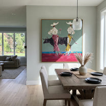 Bull Waits Between Toasts - bull cocktail cowgirl painting by Ethan Mercer, contemporary Western square wall art – styled room scene view 3