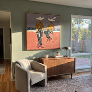 Gold Shirts Hold Horizon - modern cowboy pair painting by Ethan Mercer, contemporary Western square wall art – styled room scene view 1