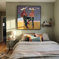 White Ribbons Cross Blue - seated cowgirl pair painting by Ethan Mercer, contemporary Western square wall art - styled room scene view 3